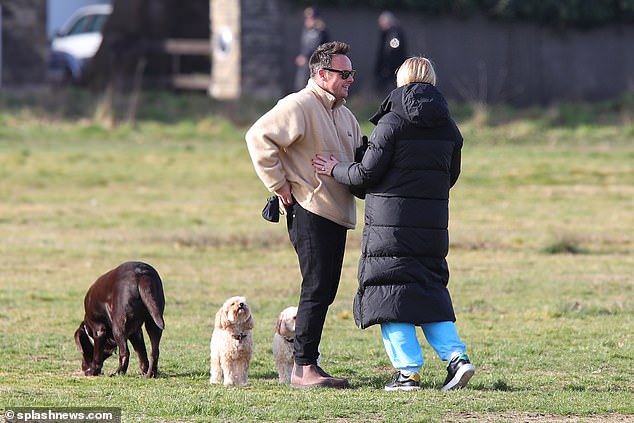 Stepping out: The couple were out walking with Hurley and their two maltipoos (Maltese and poodle crossbreeds), called Milo and Bumble