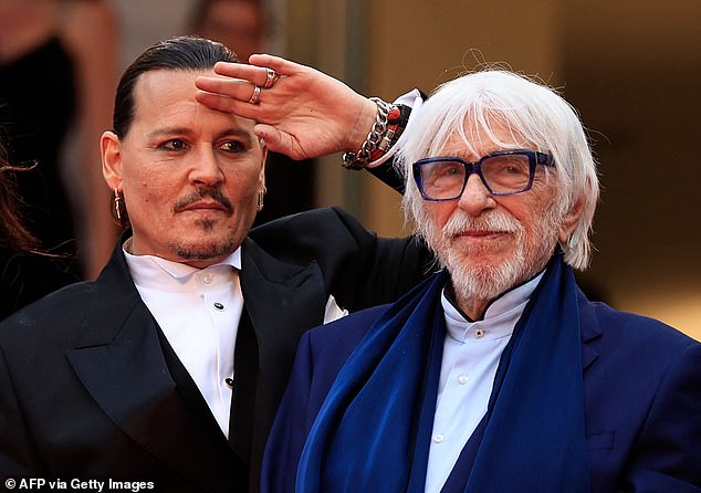 Salute: Johnny (left) appeared in great spirits as he posed alongside French actor Pierre Richard (right)