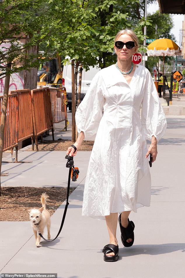 Naomi Watts stepped out in a white dress as she stepped out for a stroll in New York with her dog on Monday as she continues to spark speculation she is set to marry her partner Billy Crudup by flashing her huge 'engagement ring'