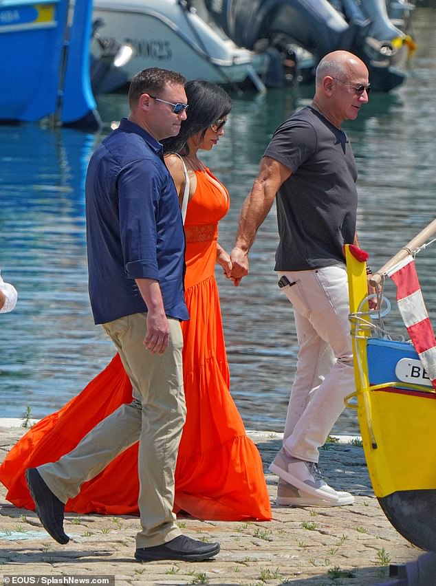 The couple was joined by a bodyguard as they walked around the marine together