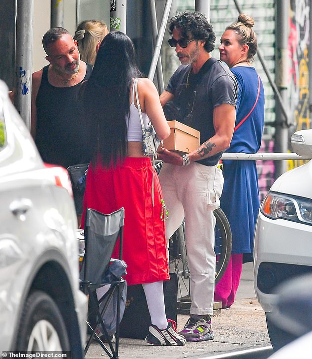 Red hot: The daughter of pop music icon Madonna sported a pair of white, over-the-knee socks underneath the shorts and teamed the look with a pair of red, white, and black. sneakers