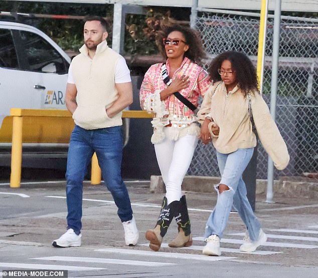 Rory dressed casually in blue jeans, a white T-shirt and vest as he walked nearby