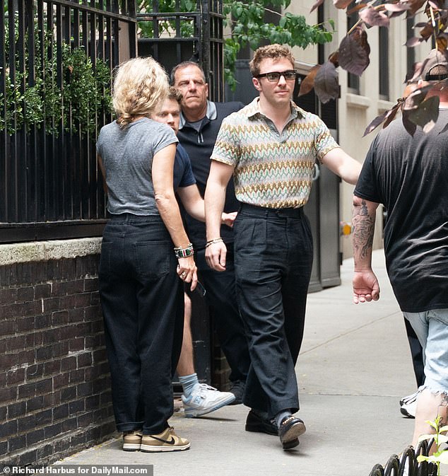 There for her: Rocco smiled as he left the apartment after a visit