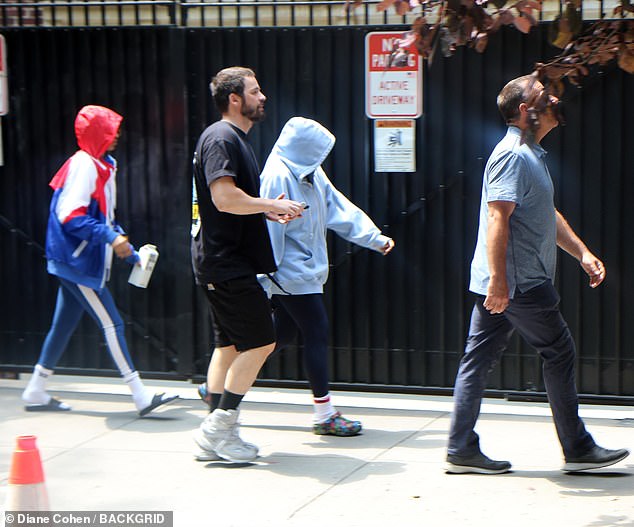 Close by: Her 10-year-old twin daughters, whom Madonna adopted back in 2017, were seen strolling through the streets of the city while sporting hooded sweatshirts for the outing