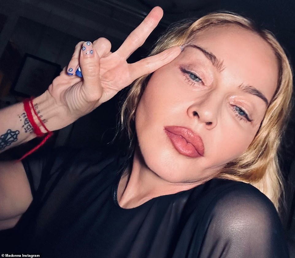 Madonna shared some words of encouragement with her fans on Friday. The 64-year-old artist posted a trio of snaps on her Instagram Stories, encouraging her followers to 'Follow The Joy.' In the pictures, she looked glamorous, wearing the same leather and mesh corset top she had worn in a video celebrating the 40th anniversary of her first album. Her makeup featured a flattering soft rose gold lip. In the first picture, Madonna faced the camera head-on, with a slight pucker of her mouth, and a glimpse of her tongue jutting between her teeth.