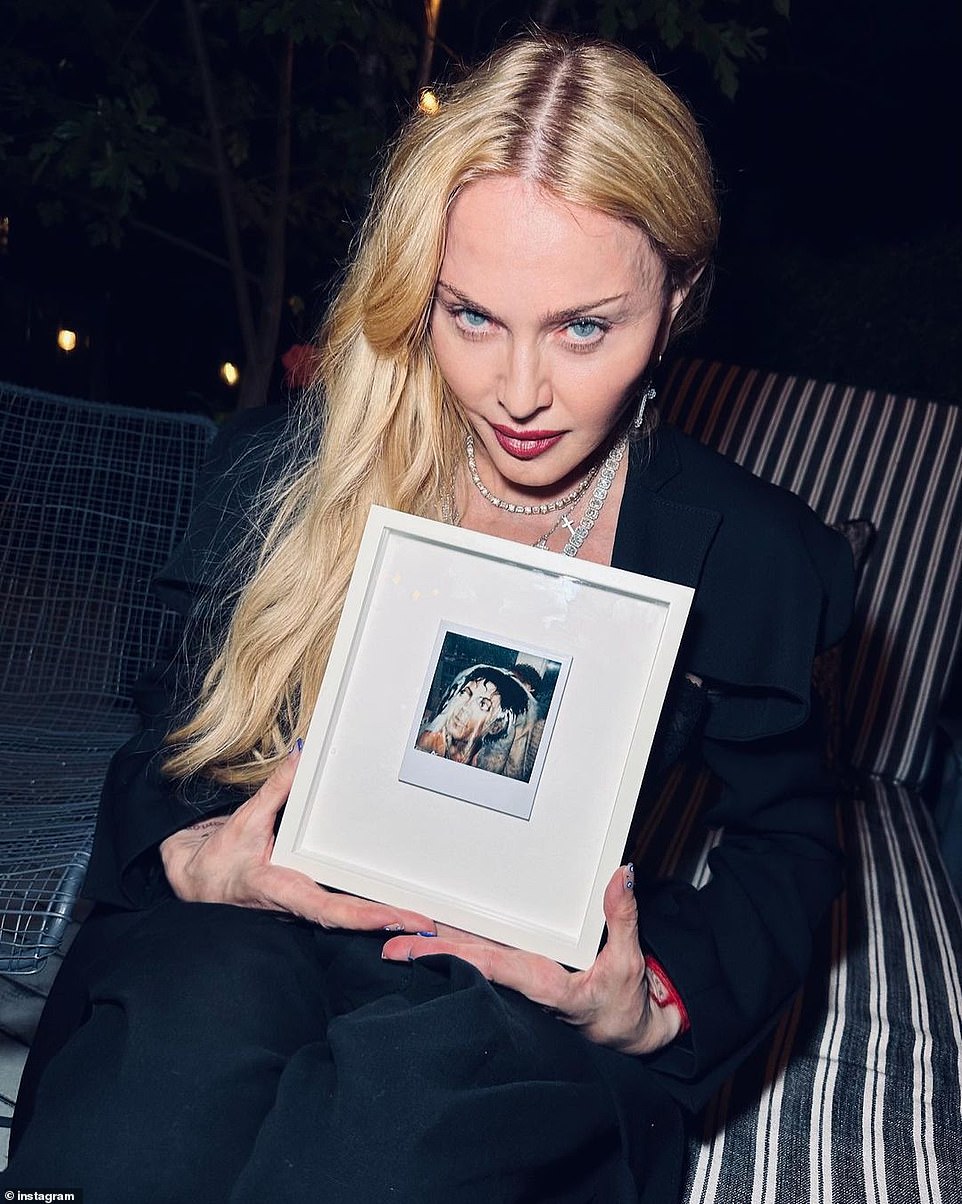 Madonna's Instagram post included a photo of her holding a framed Polaroid taken by Andy Warhol of Keith Haring wearing a jacket with Michael Jackson's face. She reflected on her gratitude for being alive and for knowing these influential artists who have passed away. Madonna thanked her manager, Guy Oseary, for the gift and expressed her appreciation for all the angels who protected her. Supportive comments poured in from friends and fans. The pop icon, who will soon celebrate her birthday on August 16, was rushed to the ICU and intubated after being found on the floor of her NYC apartment on June 24.