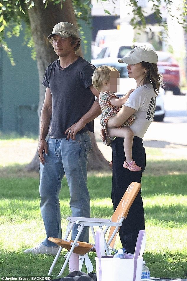 The actress accessorized with a white cap, hoop earrings and a necklace on the outing