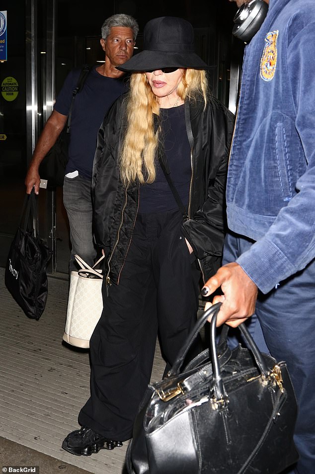 Layering up: Madonna stood out while wearing a crewneck sweater underneath a slightly oversized bomber jacket