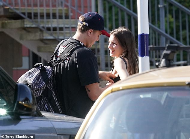 A helping hand! Roman was helping readjust her bra as they stood outside