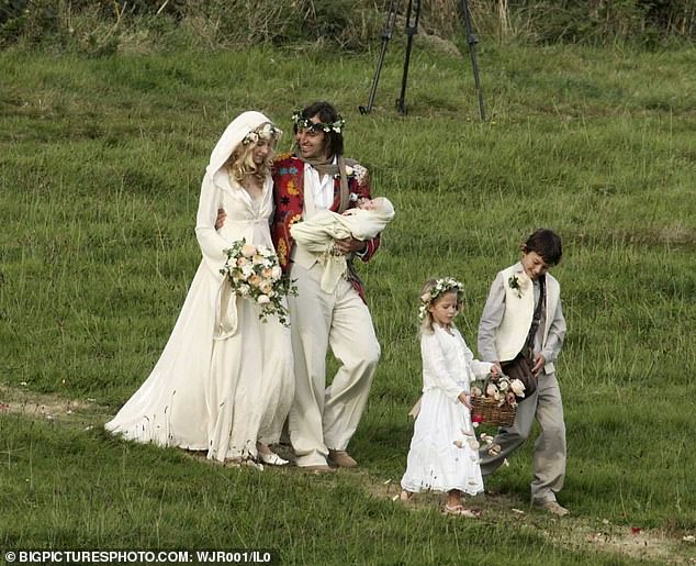 On her wedding day in 2005 with first husband Nick Skinner and baby Moses. The dress was Savannah's own design