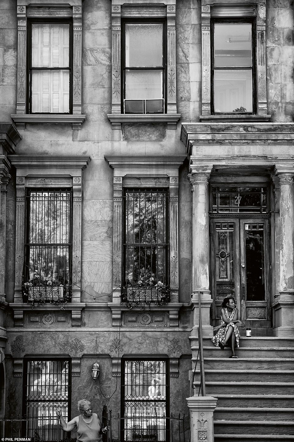 Two women are seen going about their days in Harlem before the pandemic in June, 2018