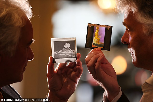 Ben and Robert Ogden holding lantern slides from the exhibition