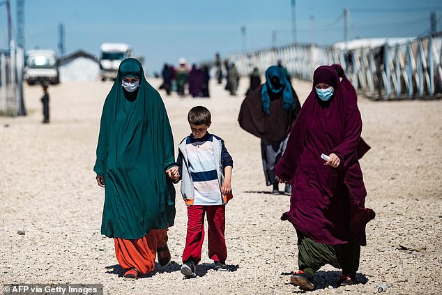 Eleven women and 20 children living in a refugee camp in Syria after the fall of ISIL have today launched an extraordinary bid to return to Australia. Pictured, women and children at the al-Roj detention camp in northeast Syria