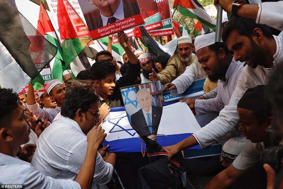 BANGLADESH: Bangladeshi Muslim activists try to set fire on the Israel's flag and the effigy of the Prime Minister Benjamin Netanyahu as they protest against Israel's actions against Palestinians after Friday prayer at the Baitul Mukarram National Mosque in Dhaka