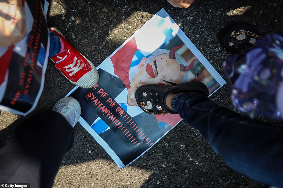 MALAYSIA: Children step on a banner with the face of Israeli Prime Minister Benjamin Netanyahu as Malaysian Muslim activists and Palestinian nationals gather to express solidarity with the people of Palestine on Friday