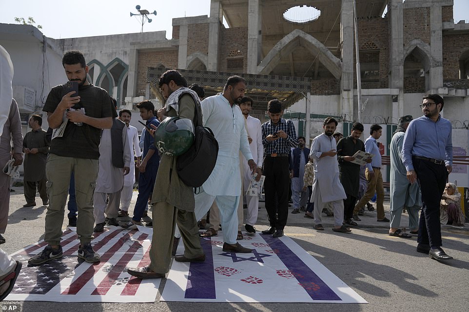 PAKISTAN: Shiite Muslims leave a mosque after Friday prayers as they walk over the representations of Israeli and the U.S. flags as a protest against Israeli airstrikes on Gaza and to show solidarity with Palestinian people, in Islamabad on Friday