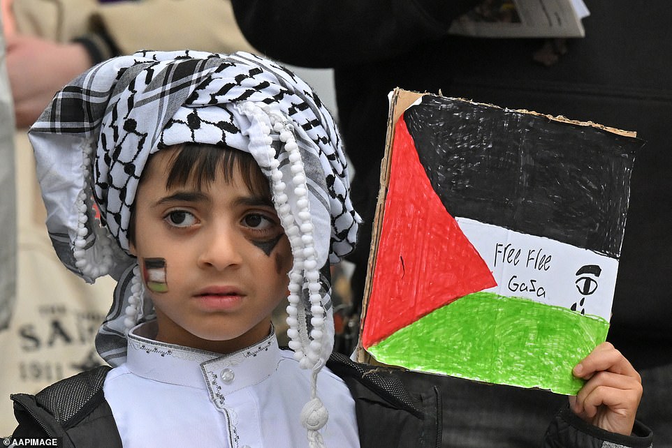 AUSTRALIA: A child participates in a rally against the occupation of Palestine and the conflict between Israel and Hamas in Canberra on Friday