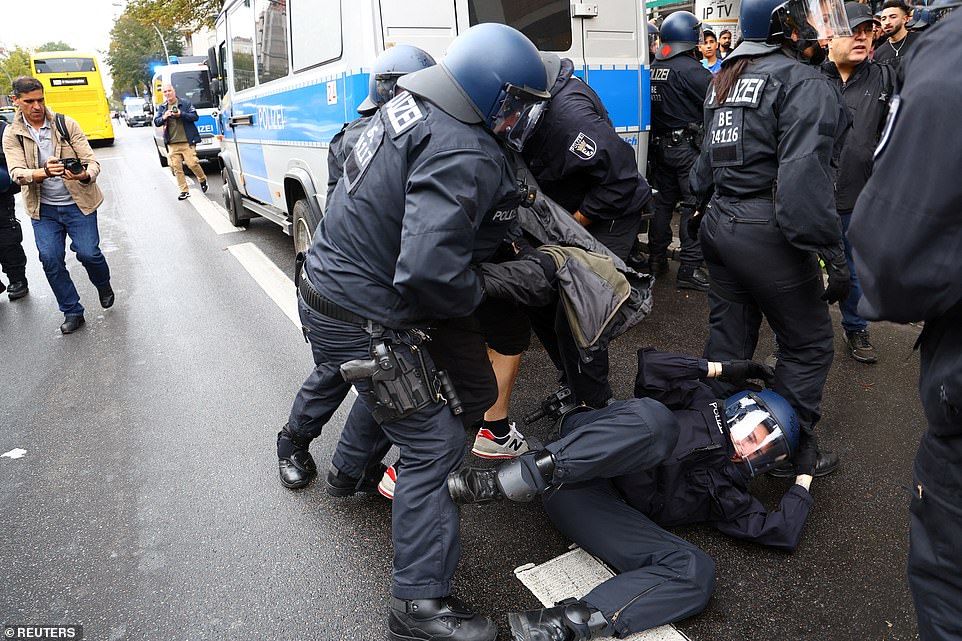 GERMANY: A Pro-Palestinian demonstrator is detained at a protest during the ongoing conflict between Israel and the Palestinian terrorist group Hamas in Berlin on Friday