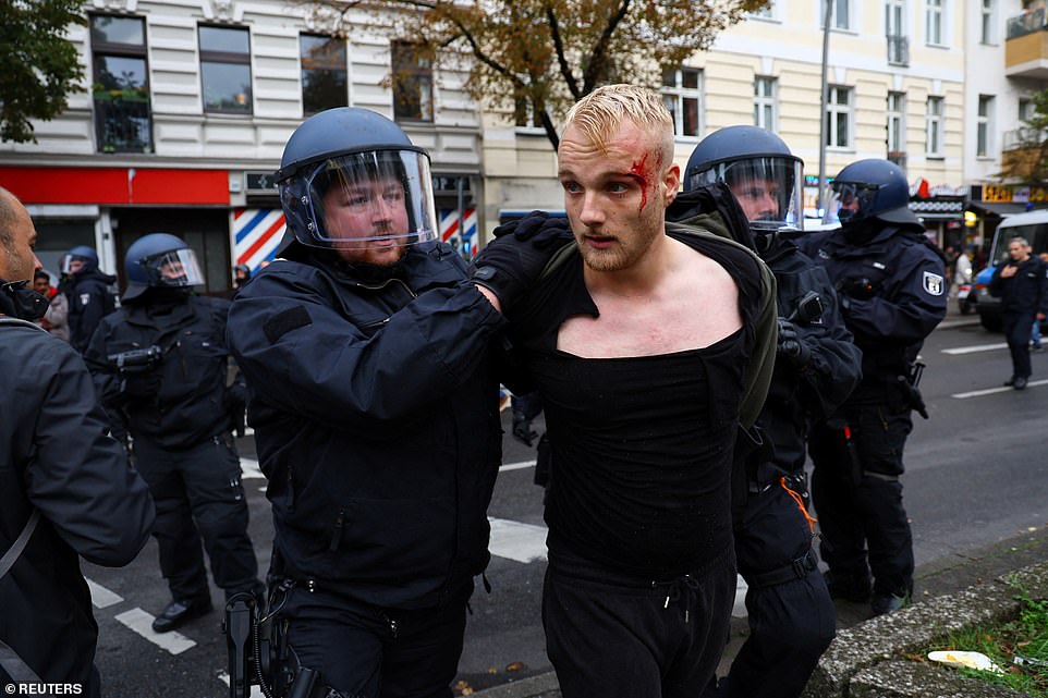 GERMANY: A Pro-Palestinian demonstrator is detained during a protest during the ongoing conflict between Israel and the Palestinian Islamist group Hamas, in Berlin on Friday