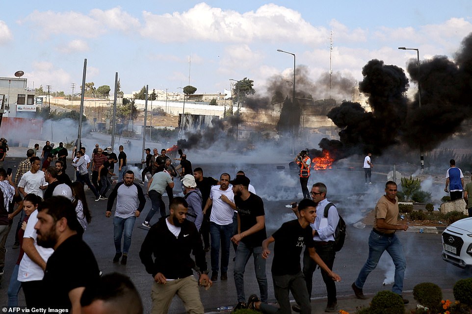 WEST BANK: Palestinians scatter during clashes with Israeli soldiers at the north entrance of the Palestinian city of Ramallah, near Beit El Jewish settlement, in the occupied West Bank on Friday