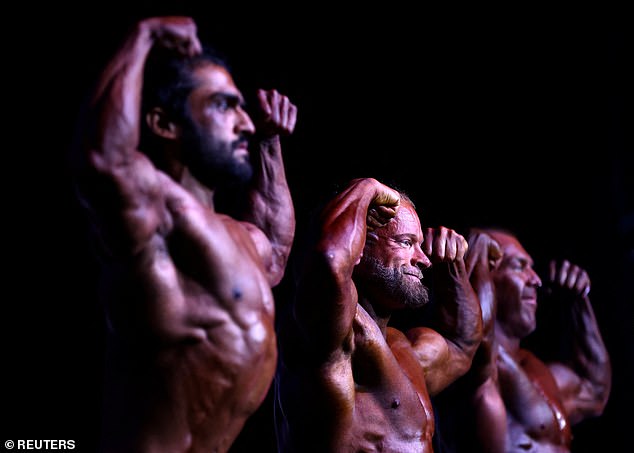 Male bodybuilders compete on stage during the IBFA British Finals Night of Champions contest at the Federation Brewery in Gateshead