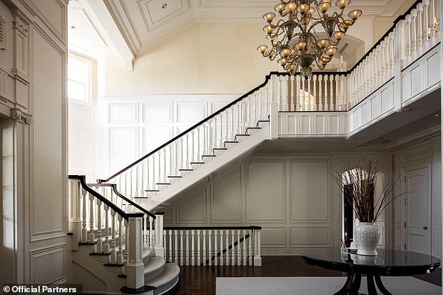 The large foyer leads into a formal living room and a gourmet chef's kitchen