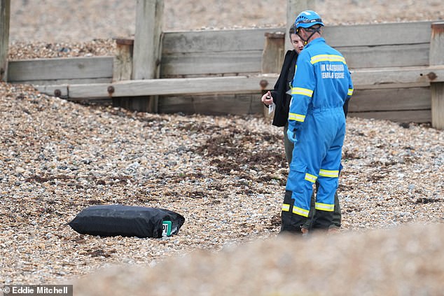 FERRING: Armed guards stand beside a holdall containing suspected cocaine with the letters 'POPI' on them