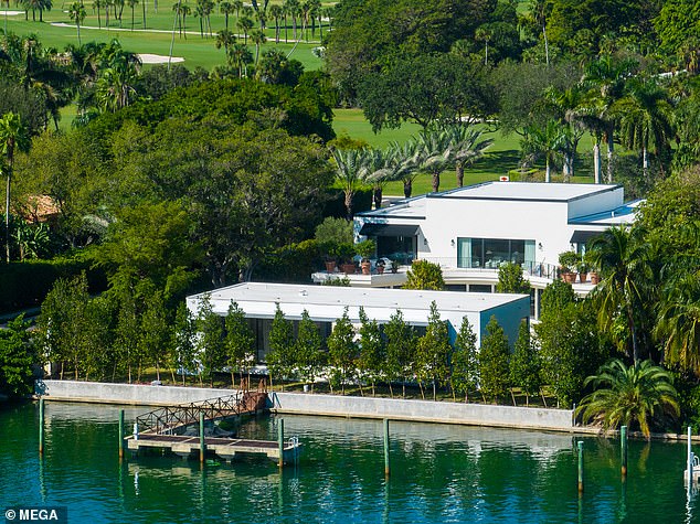 There is a bridge attached to the back of the property that leads to a private dock where they can store a boat and jet skis