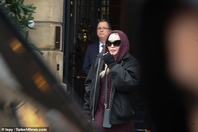 Casual: Madonna cut a comfy figure in her mauve ensemble, teamed with a trendy bomber jacket