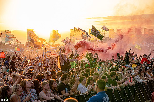 The crowd watches on as Fred Again performs on the Other Stage as the sun sets overWorthy Farm in 2023