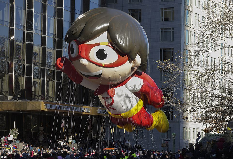 Handlers guide the Red Titan From Ryan's World balloon