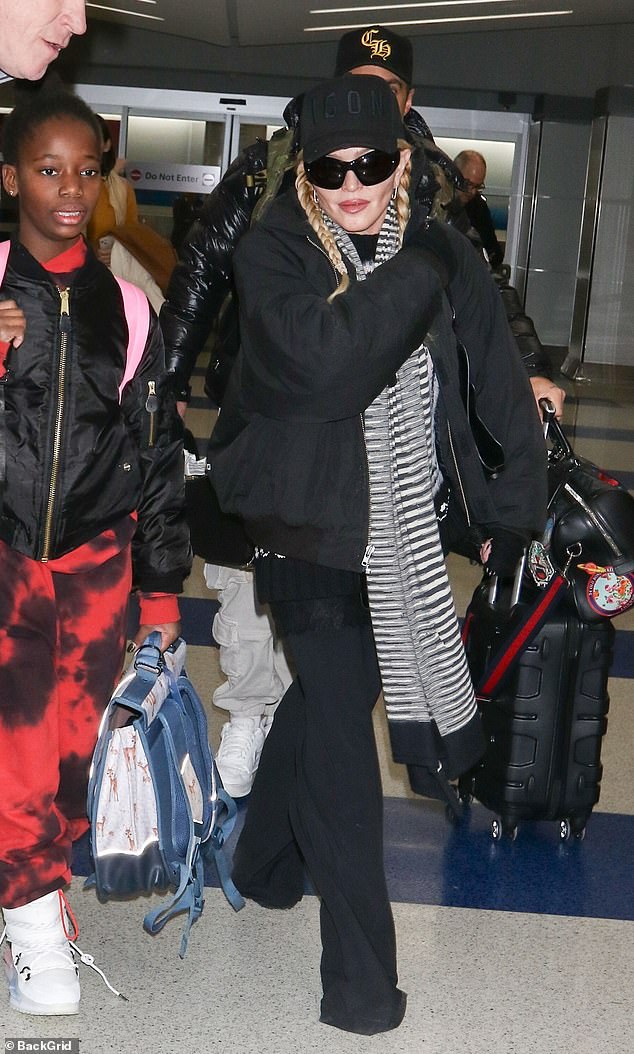 Madonna, 65, arrived with at least three of her six children at JFK International Airport in New York after spending the last two-and-a-half months performing The Celebration Tour In Europe