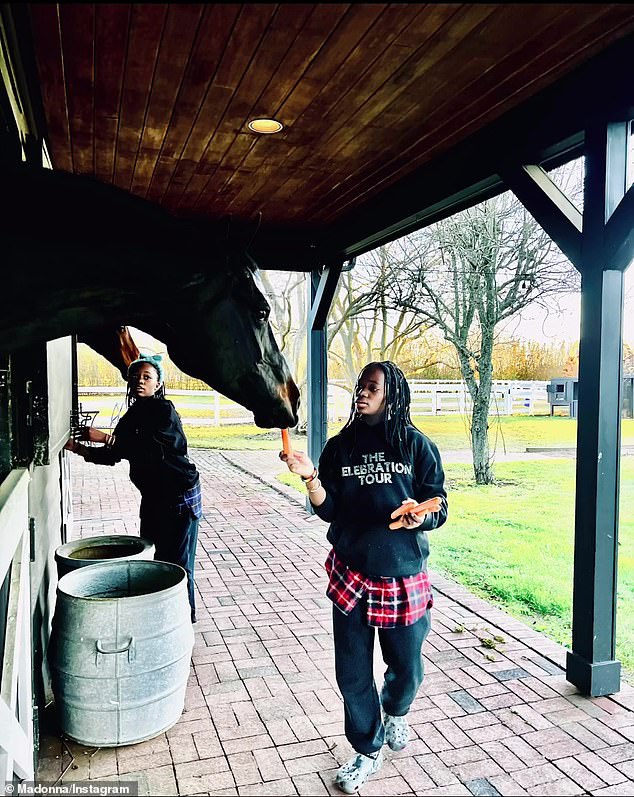 During the day, her twin daughters were also seen wearing merch from her tour and feeding carrots to horses in stables