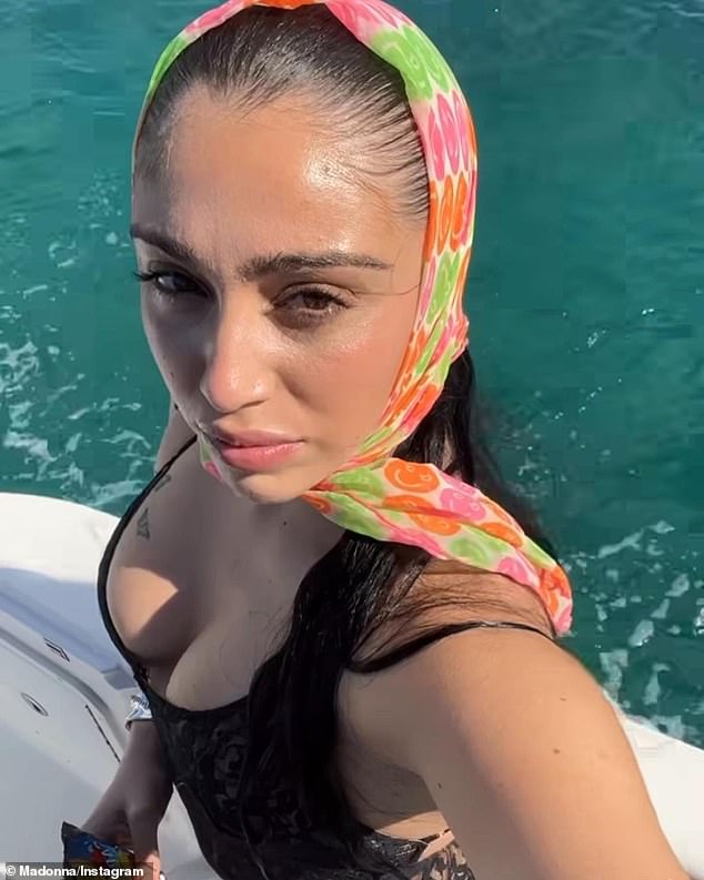 Madonna posted a selfie that the 27-year-old singer took from a boat while clad in a black-lace catsuit and colorful head scarf