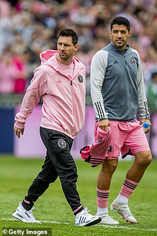 Messi and teammate Luis Suarez walk across the pitch after not playing a single second