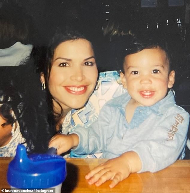 In another photo from Nikko's childhood, she is smiling brightly while cuddling up to her young son at a restaurant