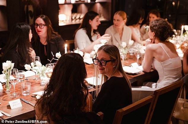 The simple-yet-chic table setting included white tulips and candles as centerpieces— on brand with the elegantly understated collection