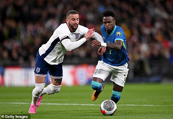 LONDON, ENGLAND - MARCH 23: Kyle Walker of England and Vinicius Junior of Brazil battle for possession during the international friendly match between England and Brazil at Wembley Stadium on March 23, 2024 in London, England. (Photo by Mike Hewitt/Getty Images)