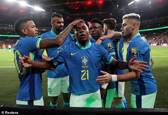 Soccer Football - International Friendly - England v Brazil - Wembley Stadium, London, Britain - March 23, 2024 Brazil's Endrick celebrates scoring their first goal with Vinicius Junior and teammates REUTERS/Carl Recine