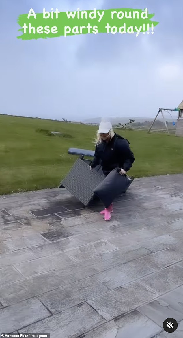 The clip captured the TV star as she battled the wind while moving chairs, tables and more, inside the house