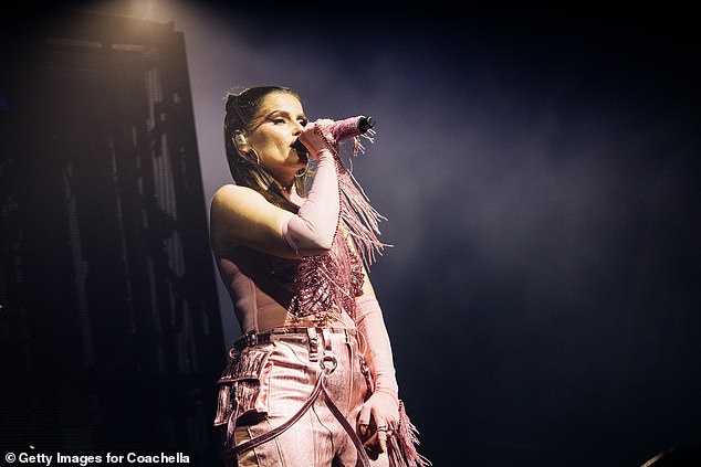 She looked incredible for the show, where she dazzled in the pink look boasting leather-look details and tassels extending the lengths of her arms