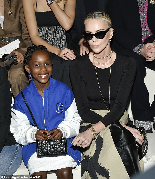 Theron with daughter August at the Christian Dior pre-fall 2024 fashion show in April