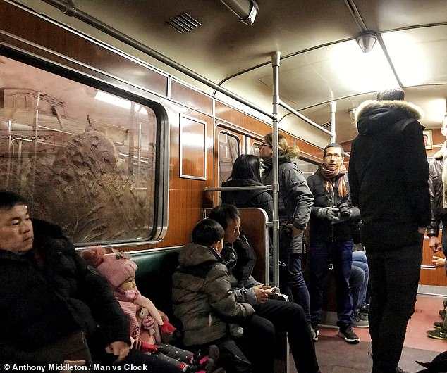 Pictured: People riding the metro system through the North Korean capital