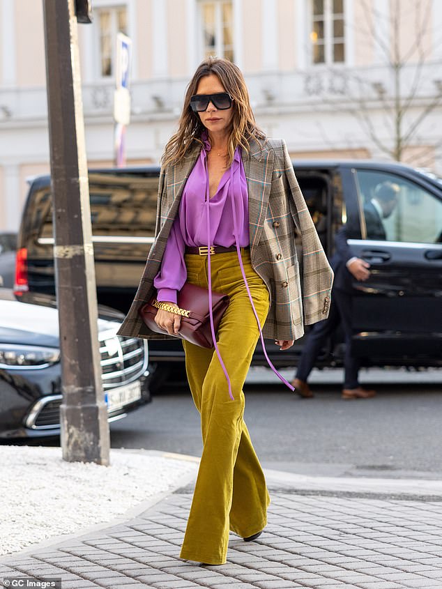 2022: Victoria turned heads as she paired a vibrant purple blouse with chartreuse trousers and a tweed jacket during a stroll around Paris