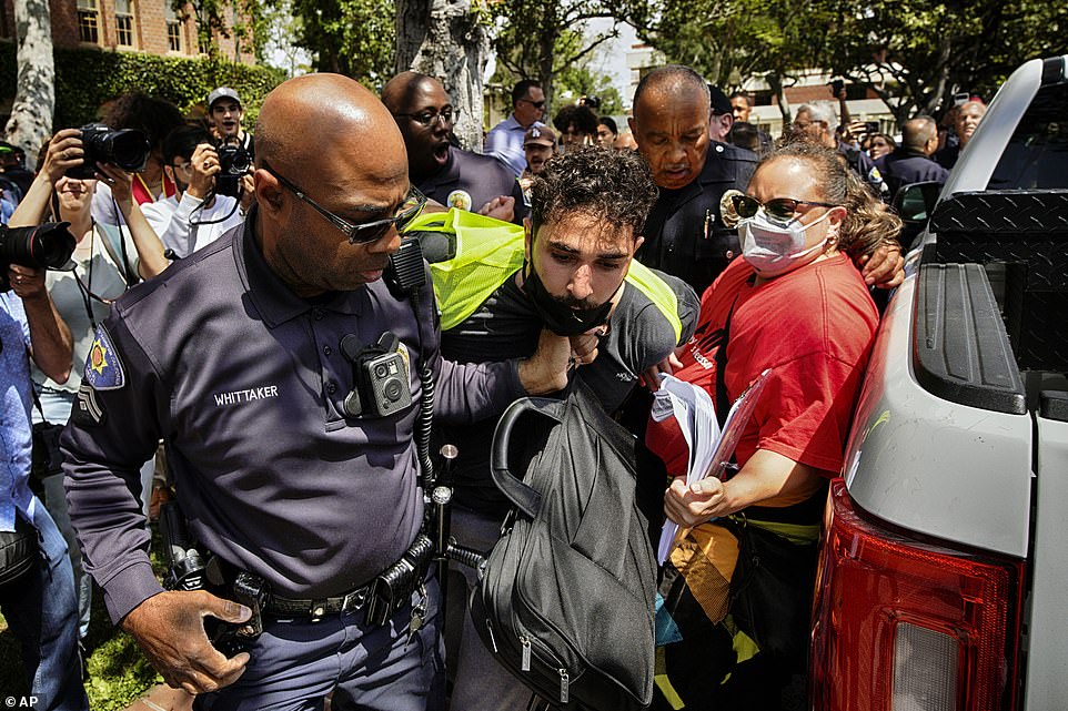 Columbia continued to negotiate with students after several failed attempts - and over 100 arrests - to clear the encampment, but several universities ousted demonstrators on Wednesday, swiftly turning to law enforcement when protests bubbled up on their campuses. Tensions were already high at the University of Southern California after the university canceled a planned commencement speech by the school's valedictorian, who publicly supports Palestine, citing safety concerns. After scuffles with police early Wednesday, a few dozen demonstrators standing in a circle with locked arms were detained one by one without incident later in the evening. Officers encircled the dwindling group sitting in defiance of an earlier warning to disperse or be arrested. Beyond the police line, hundreds of onlookers watched as helicopters buzzed overhead. The school closed the campus.