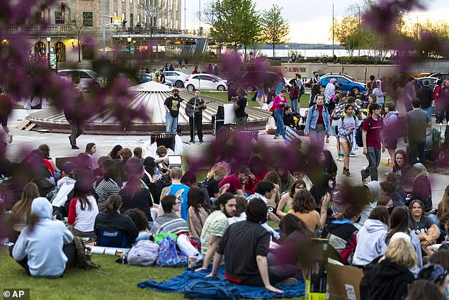 There were arrests made on campuses such as Ivy League's Dartmouth in Rhode Island , the University of Texas at Dallas, and the University of Wisconsin at Madison. Pictured: A musician plays at the University of Wisconsin protest before police moved in