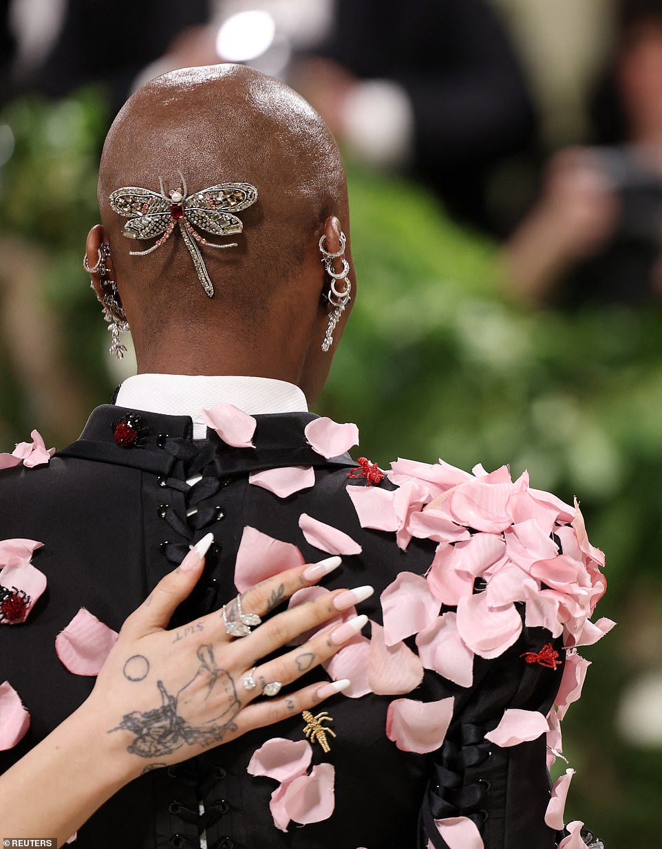 Cynthia had a butterfly jewelry piece on the back of her head and a number of diamonds earrings