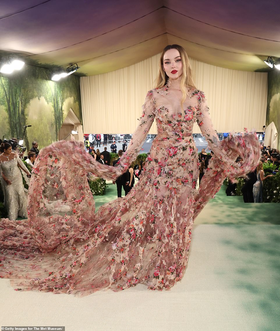 Dove Cameron was blooming in her red floral nude mesh gown by Diesel; the sleeves were long and dramatic - with a red lip as a final touch