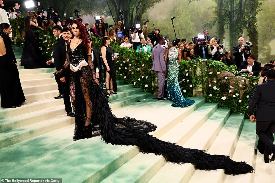 Dua Lipa wowed in a gothic black and white lace corset top and skirt by Marc Jacobs, paired with fishnet gloves