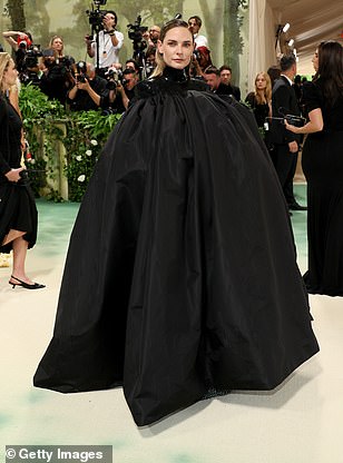 Rebecca Ferguson wore a black cape before removing it